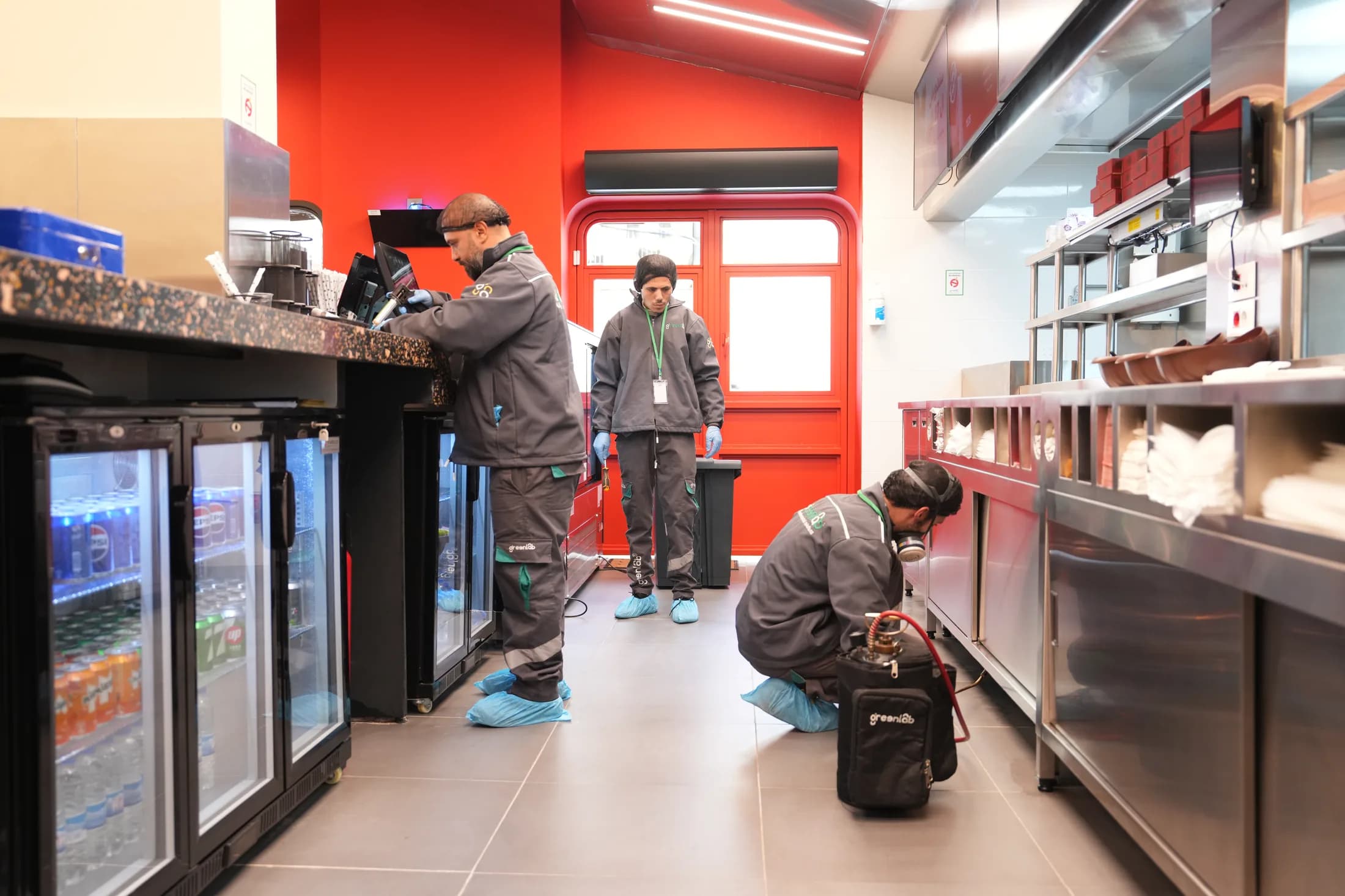 GreenLab technicians inspecting and treating a commercial kitchen.