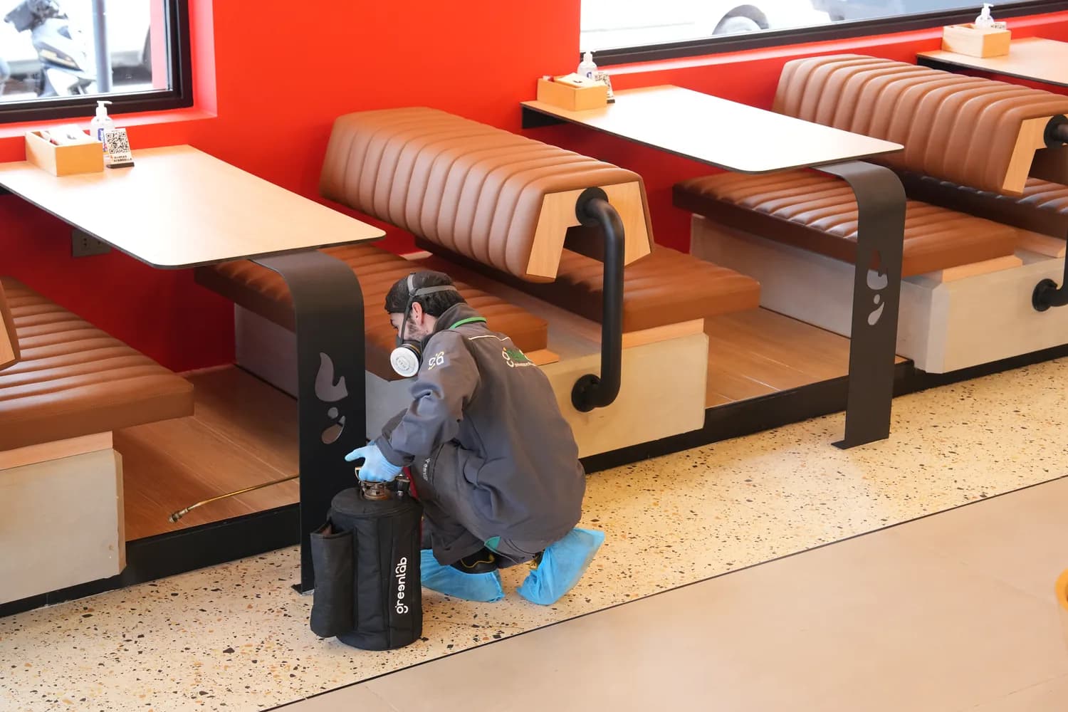 GreenLab technician servicing a hospitality environment with branded equipment.