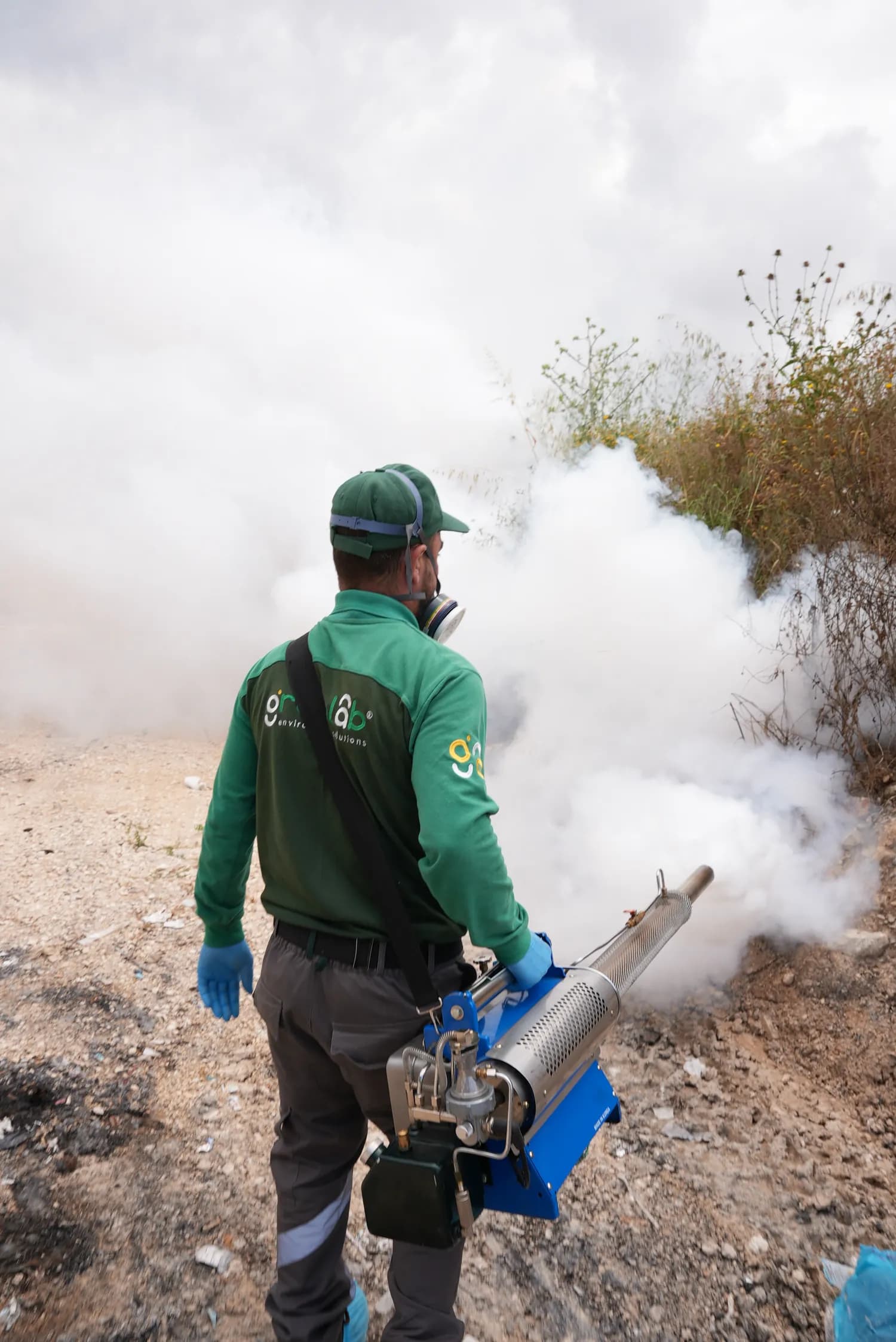 GreenLab technician treating an outdoor space with professional equipment.